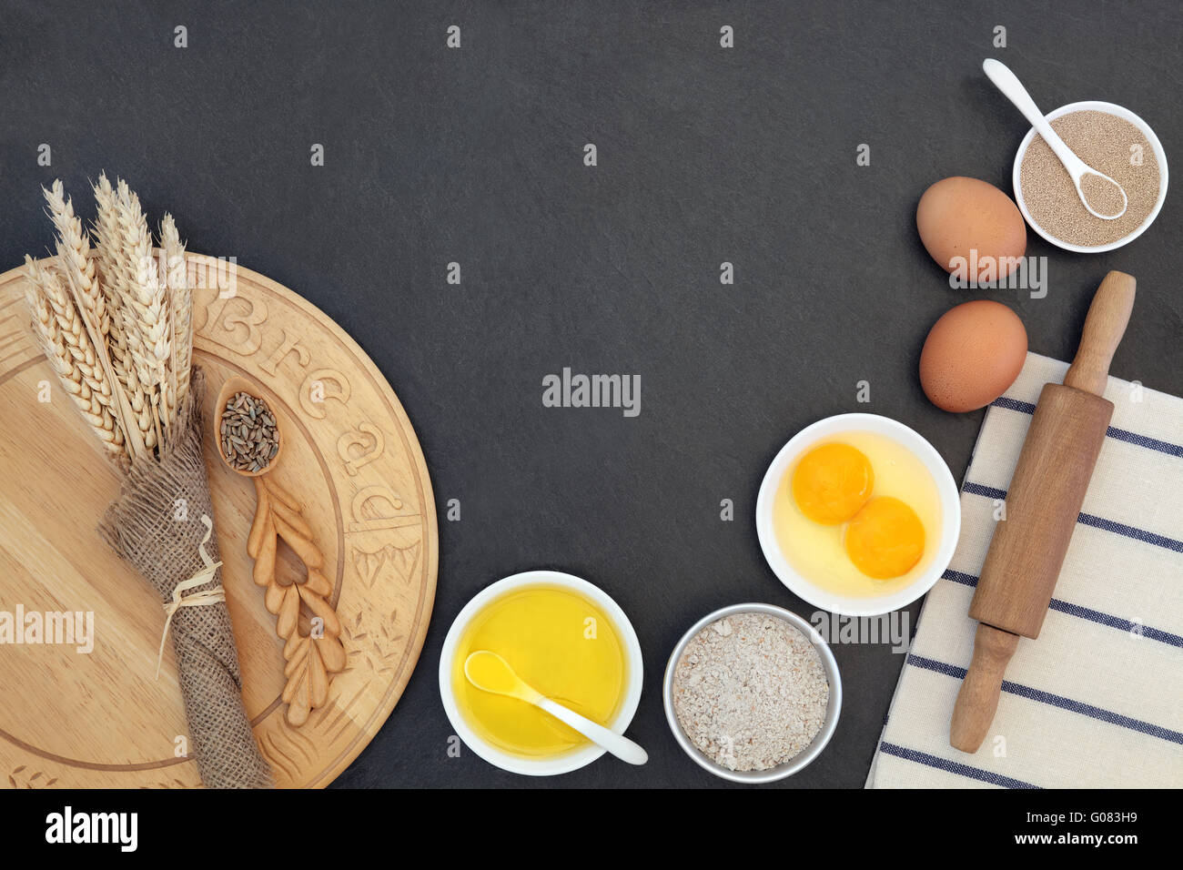 Bread baking ingredients and utensils with wheat sheaths and grain in a