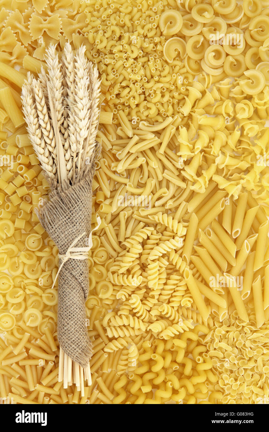 Dried italian pasta food selection with wheat bundle in hessian forming