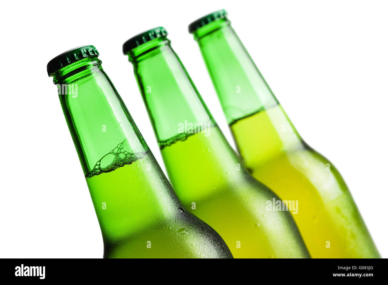 three green beer bottles isolated over white backg Stock Photo - Alamy