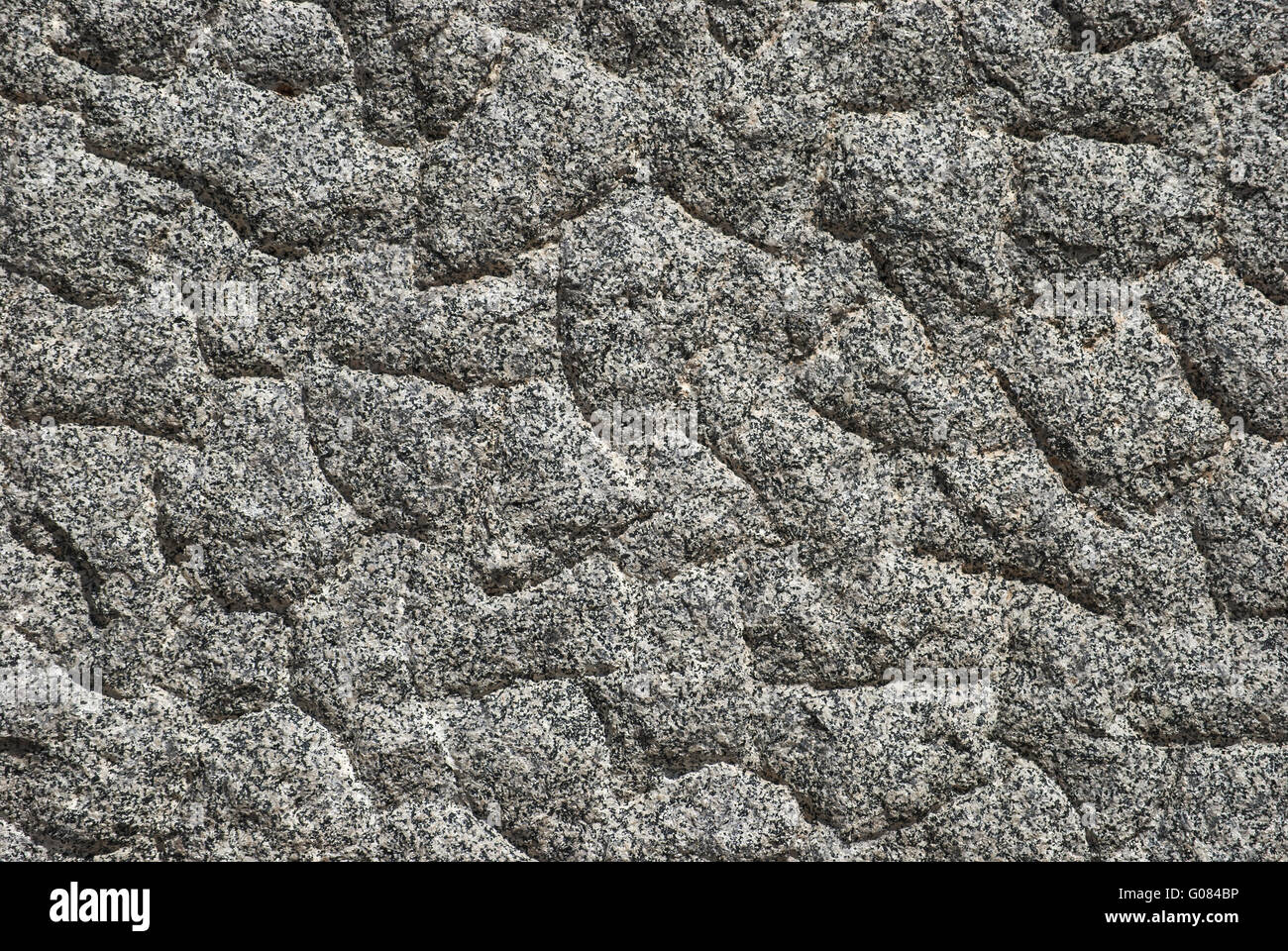 Granite block bumpy surface closeup as background Stock Photo