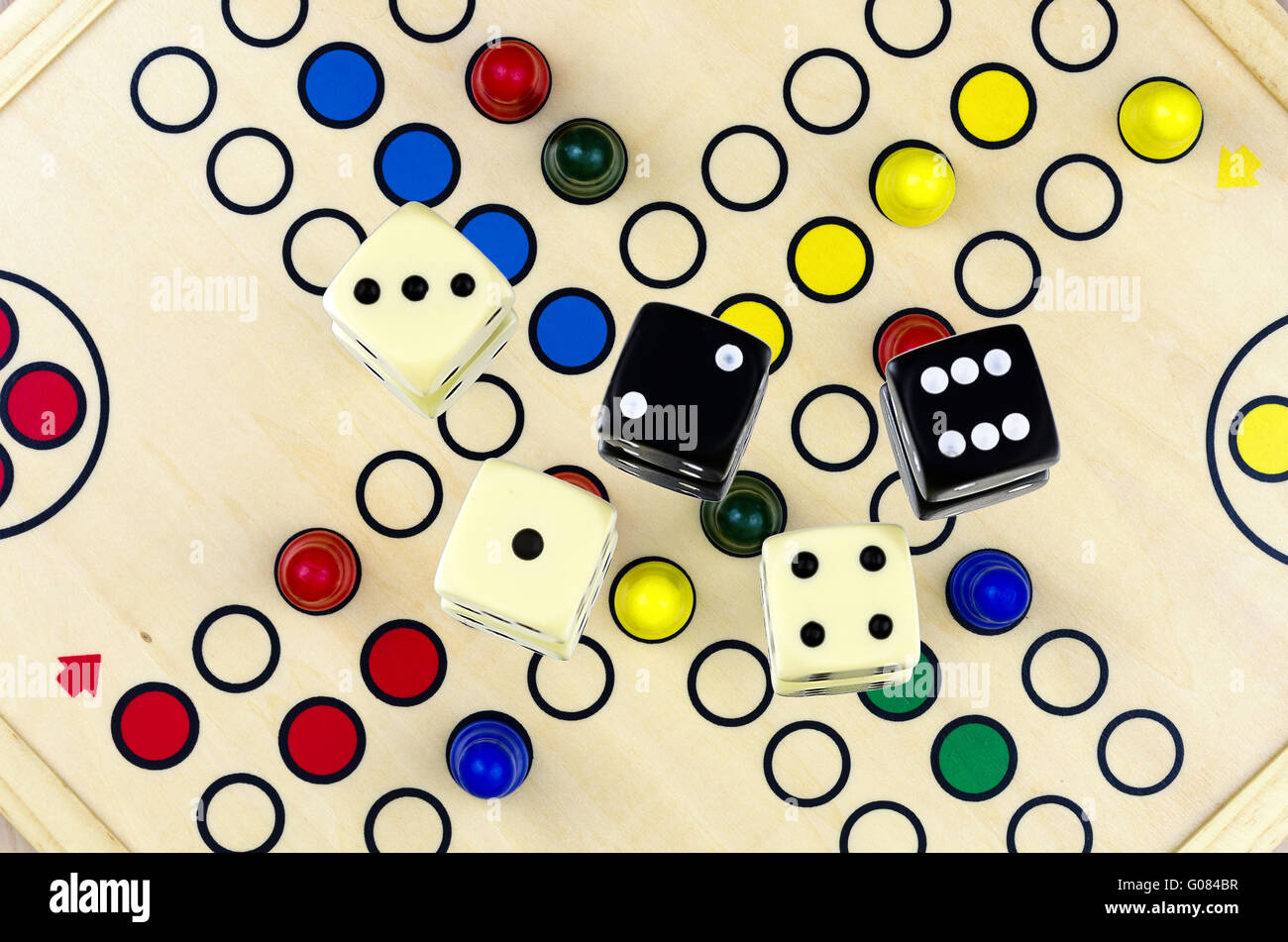 Dices on the board game parcheesi or ludo Stock Photo