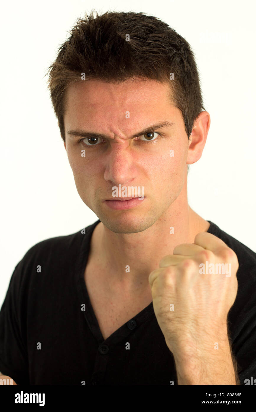 Young man showing fist and looking very aggressive Stock Photo