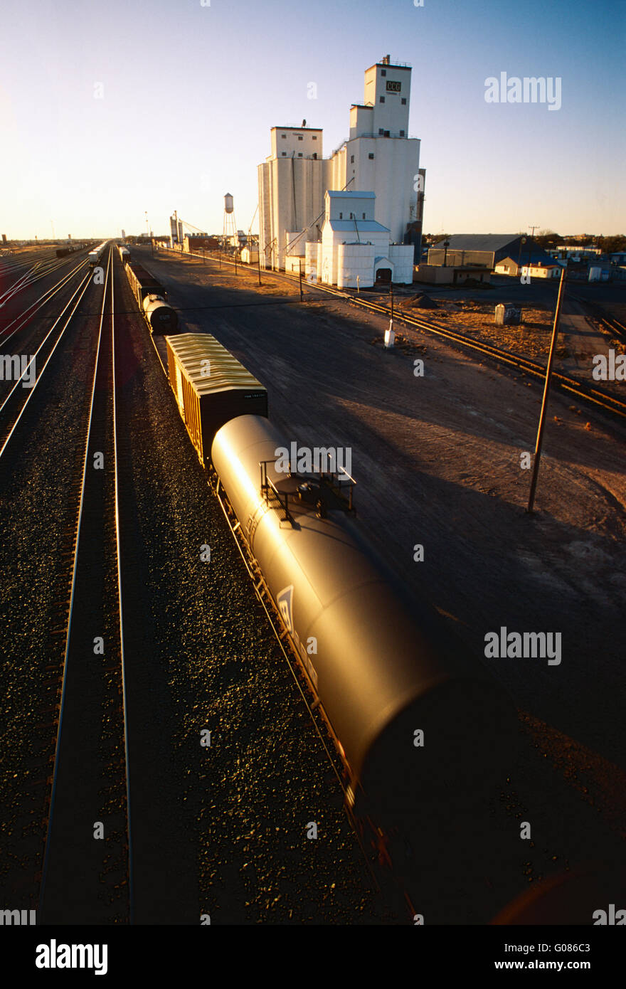 Large industrial rail yard & grain elevators at sunset; Clovis; New Mexico; USA Stock Photo