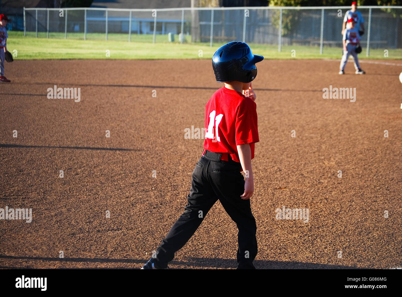 Baseball boy on third base Stock Photo