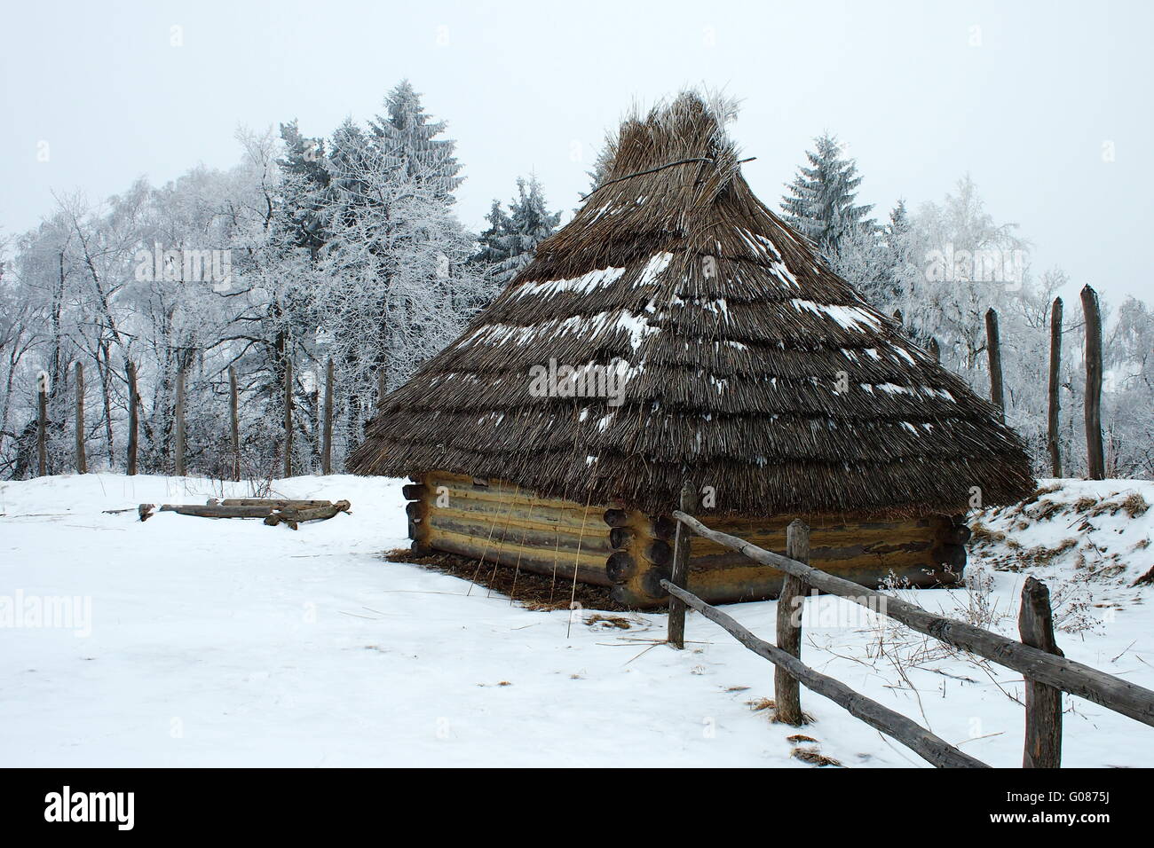 Blockhouse thatched roof winter dark middle ages Stock Photo