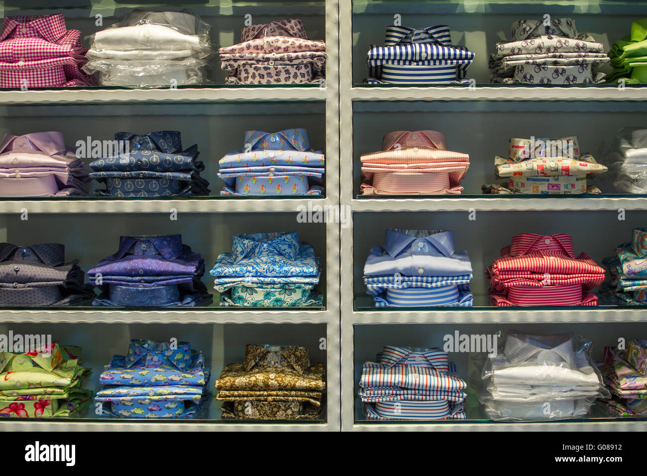 Neat stacks of folded clothing on the shop shelves Stock Photo