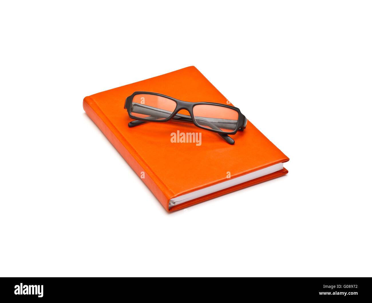Orange book and glasses, isolated on white background Stock Photo