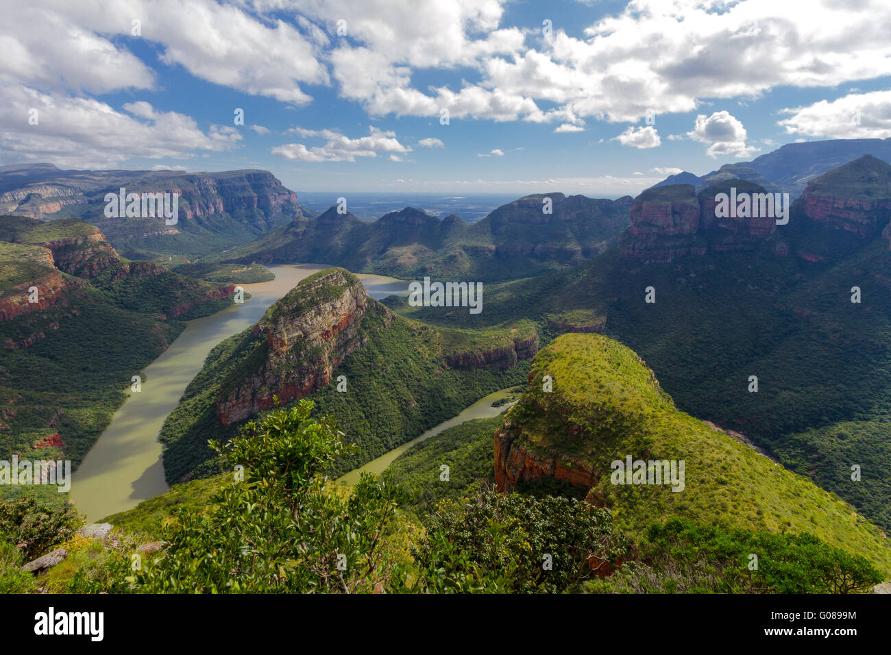 Under a beautifully patterned sky, the Three Rondavels rise up from the green floor and river of Blyde River Canyon, Mpumalanga, South Africa. Stock Photo
