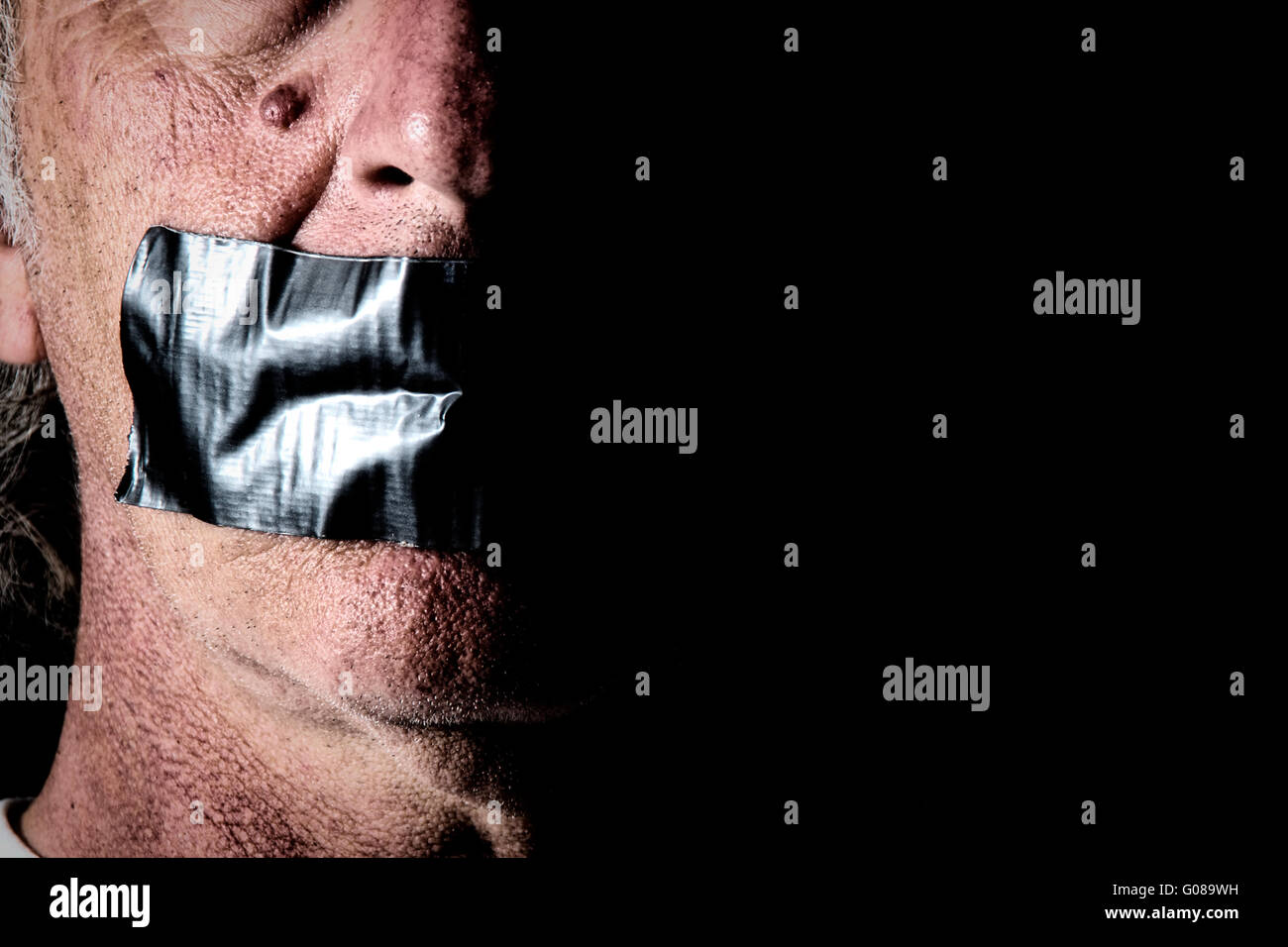 Highly detailed creepy image of man with mouth duct taped closed. Political correctness or freedom of speech , censorship concept. Stock Photo