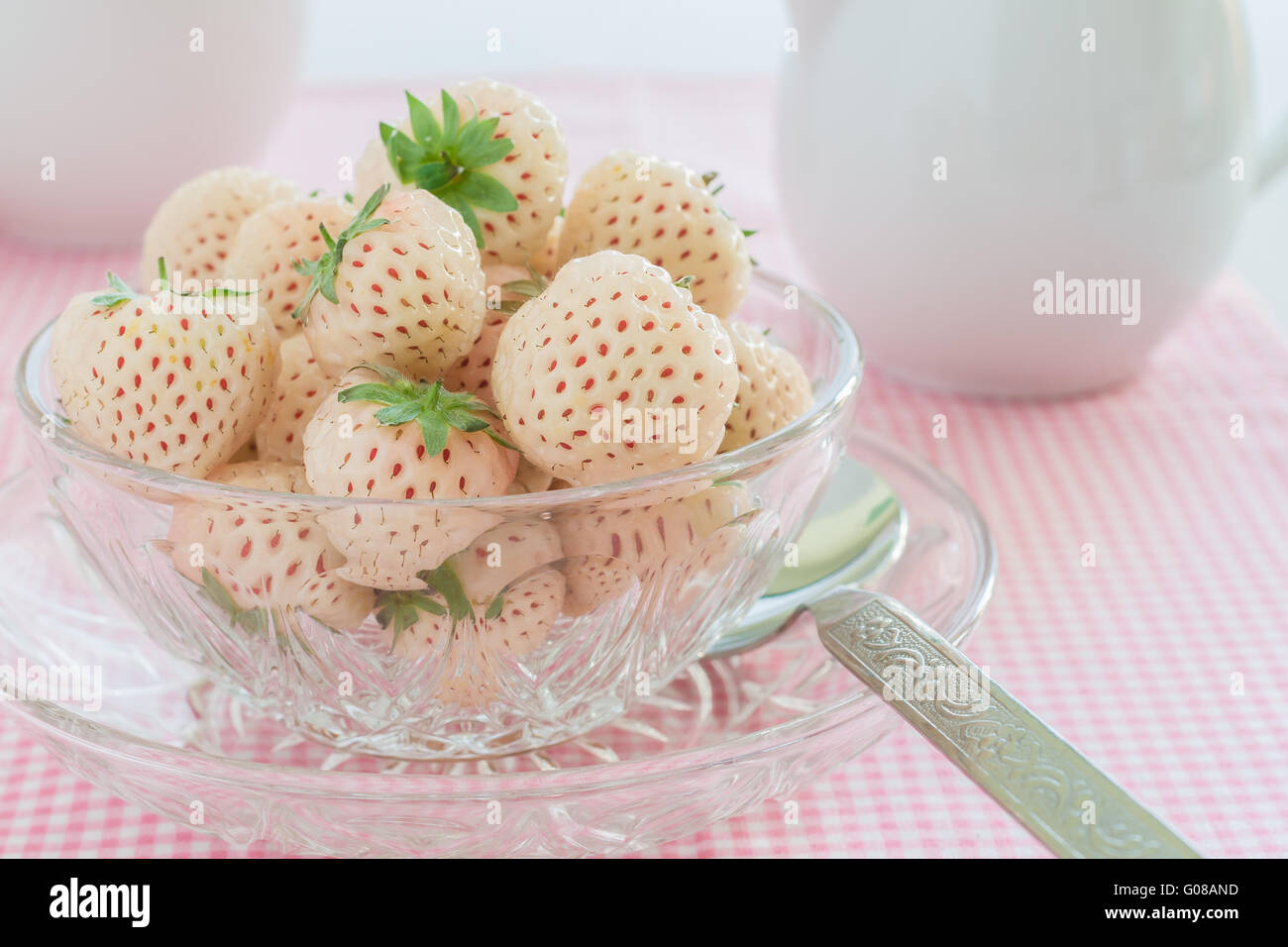 Pineberry or Hula Berry a hybrid fruit with a pineapple flavour white flesh and red seeds Stock Photo