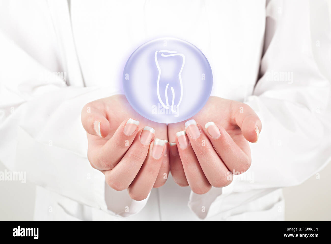 doctor woman holding teeth symbol in her hands Stock Photo