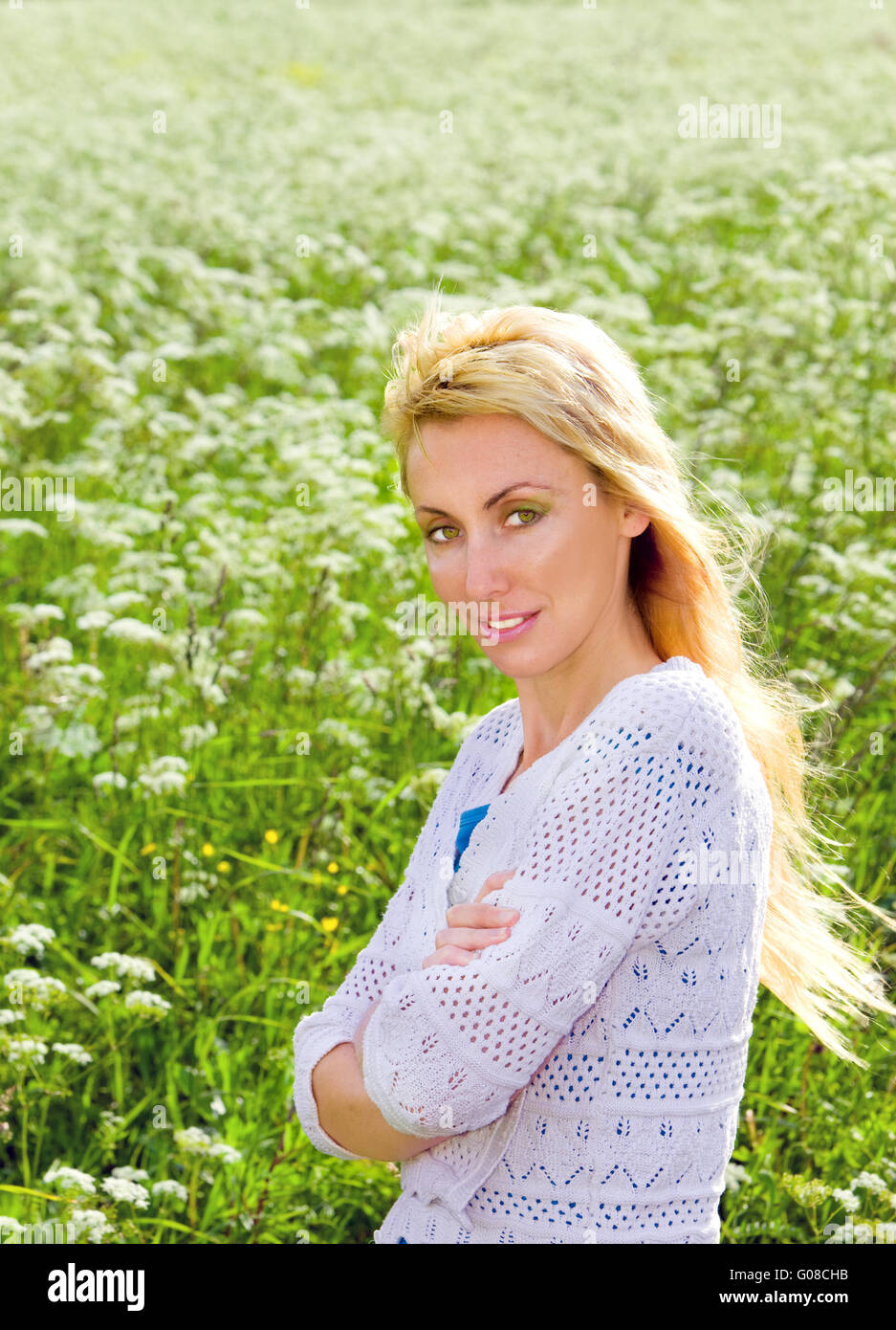 Female portrait against a meadow with white colors Stock Photo