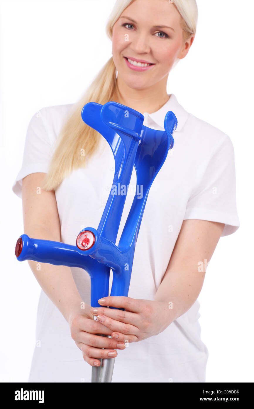 Nurse hands over two crutchs Stock Photo