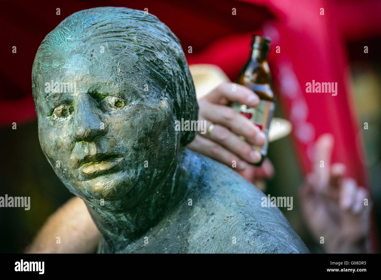 Man with beer bottle based on a bronze statue Stock Photo