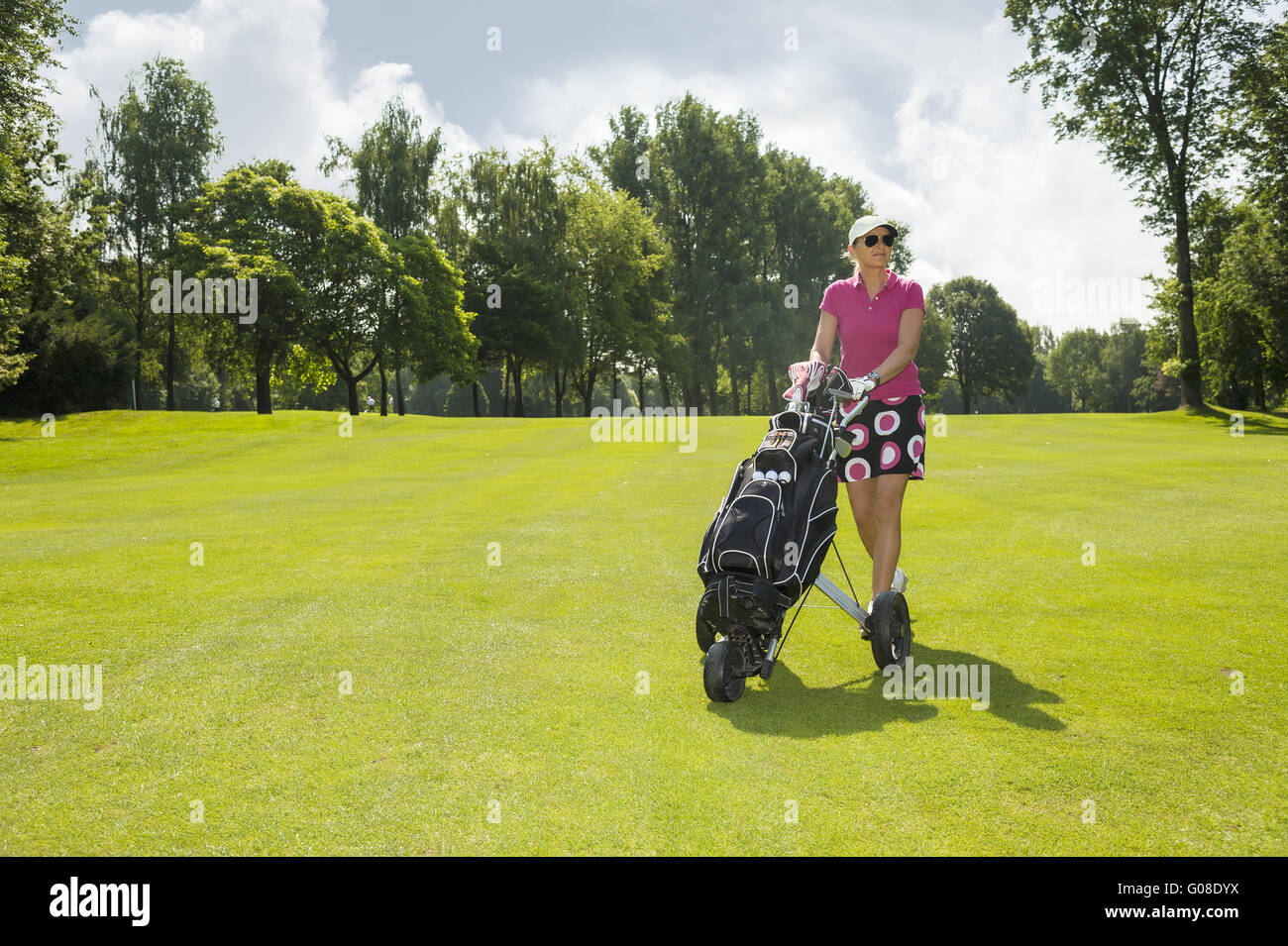 Golfer with Trolley on the square in front view Stock Photo