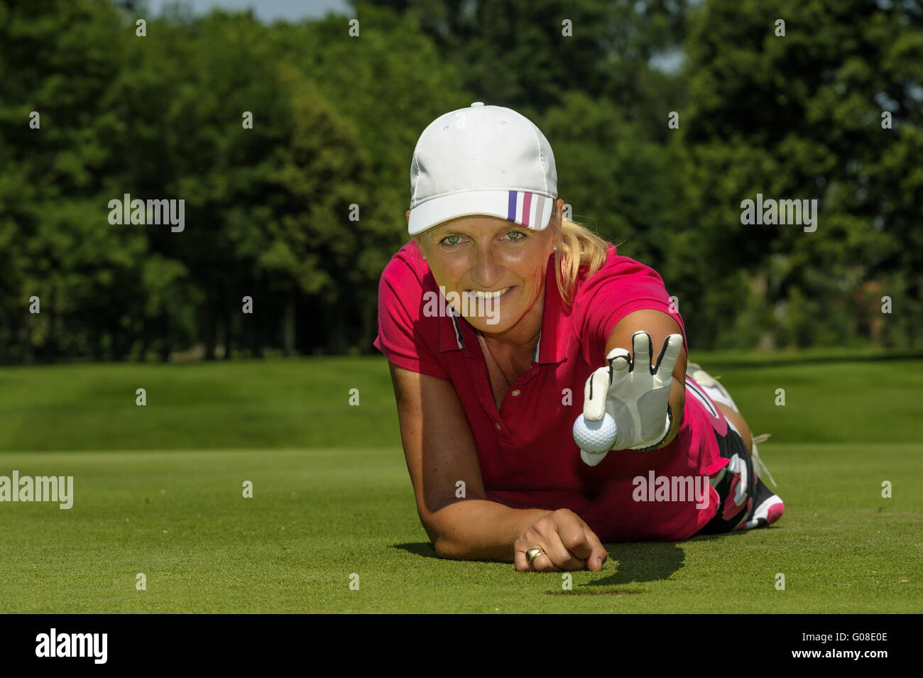 Golfer holding a golf ball with his hand over the Stock Photo
