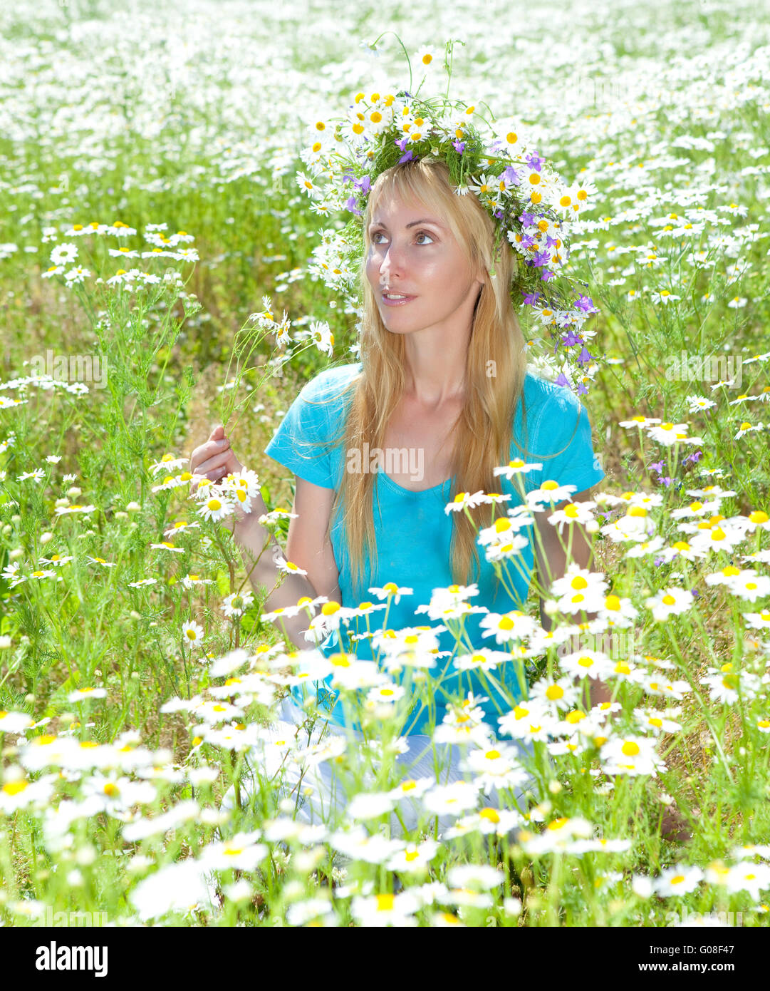 woman in a wreath from wild flowers in the chamomi Stock Photo