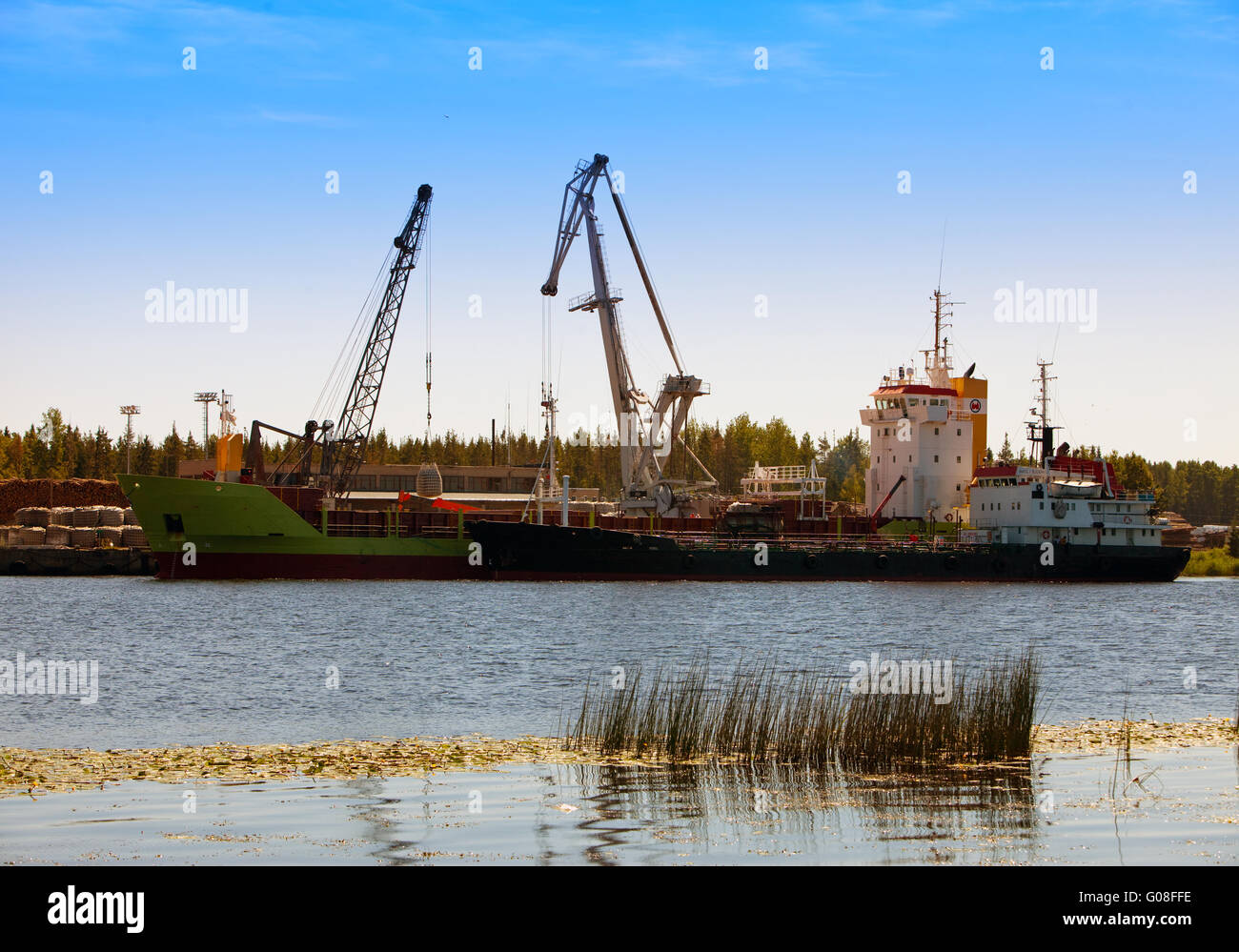 Cargoship unloading on the river Luga. Russia Stock Photo