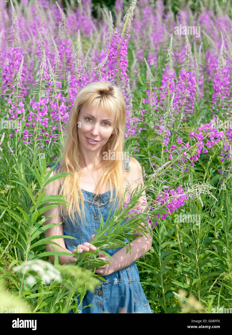 woman with bouquet of firetop flower in the field Stock Photo