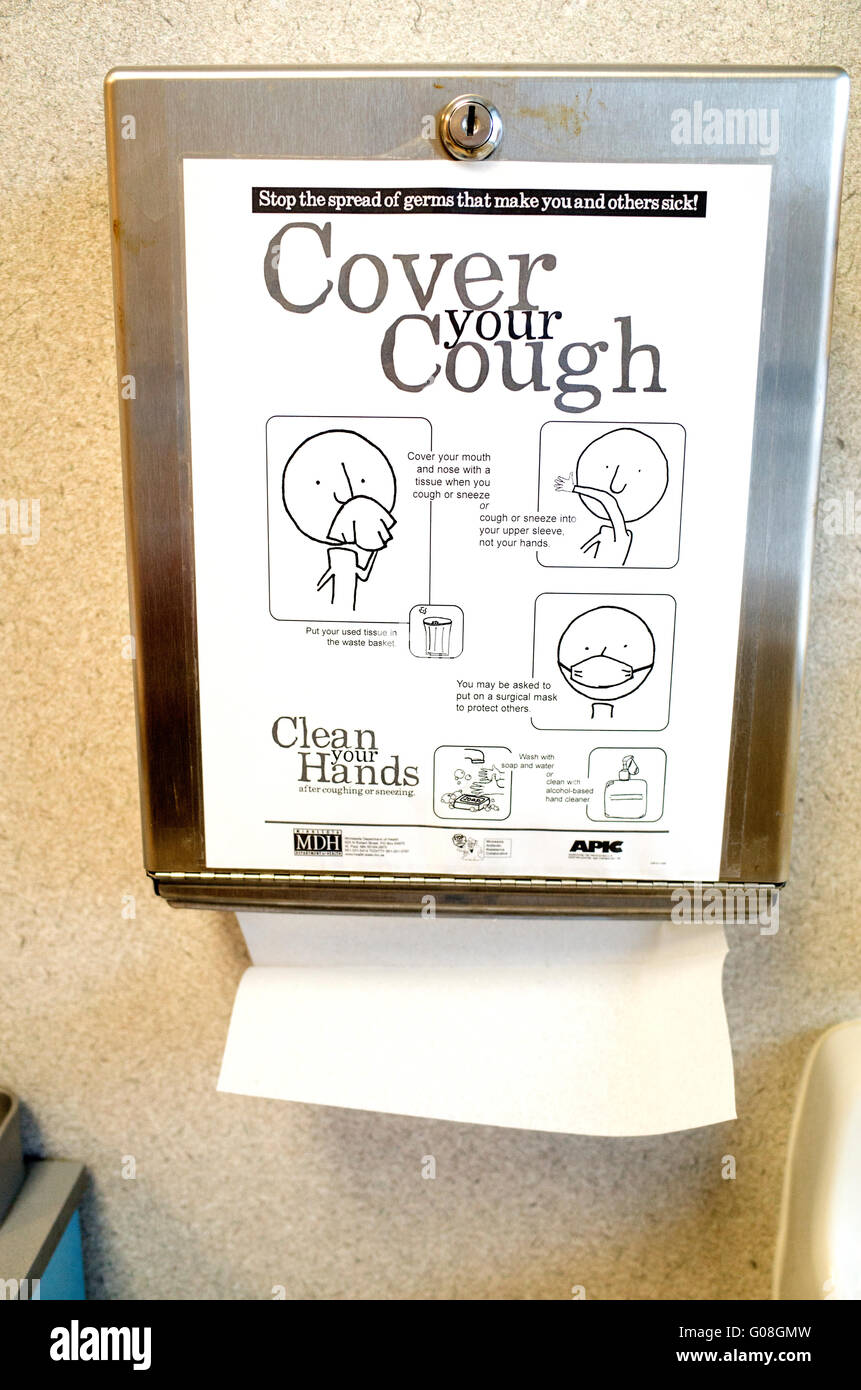 Hand drying paper dispenser with instructions on how to cover your cough and wash hands. Minneapolis Minnesota MN USA Stock Photo