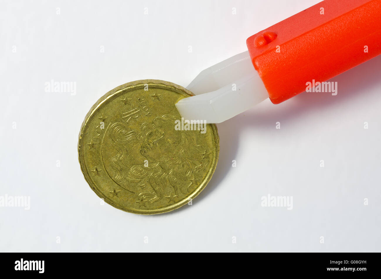 tick forceps holding italian twenty Cent coin Stock Photo