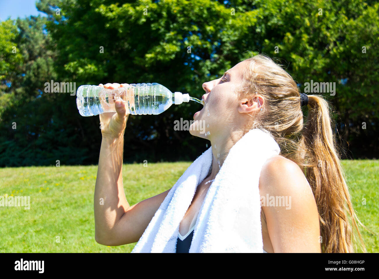 Athletic woman drinking water after a workout Stock Photo Alamy