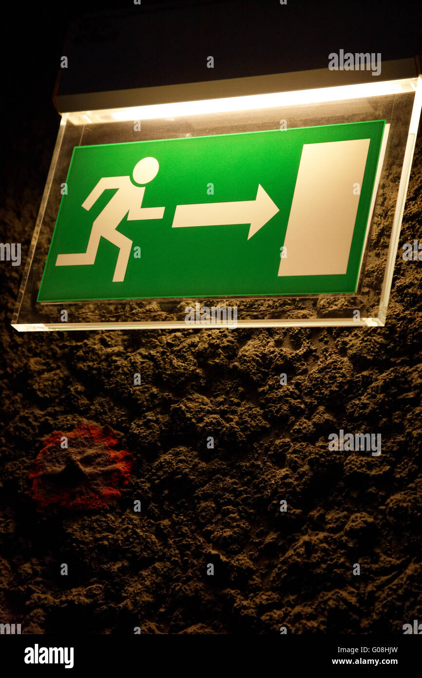 Lighted emergency exit sign. Stock Photo