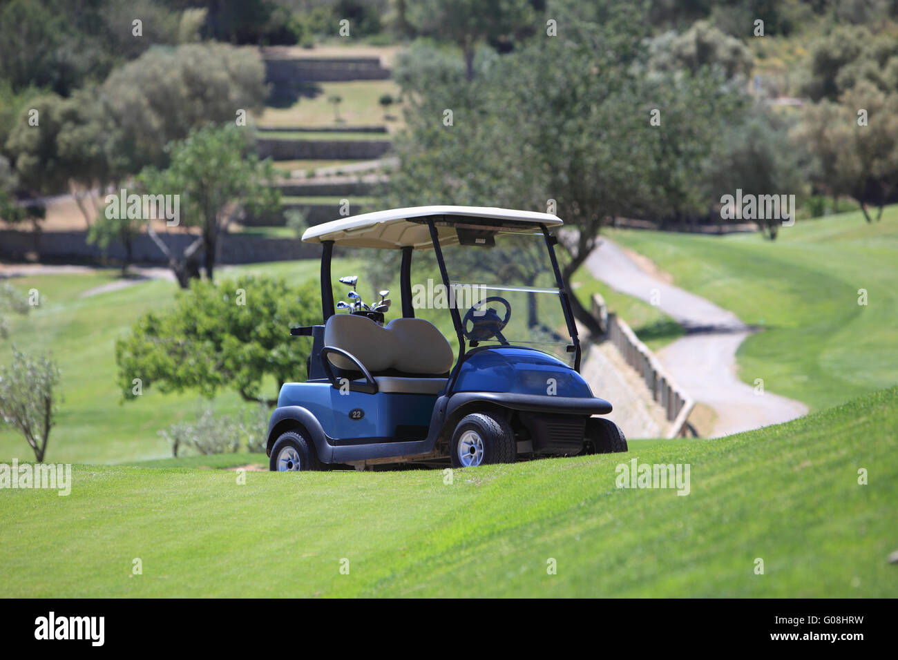 Golf cart parked on a golf course Stock Photo