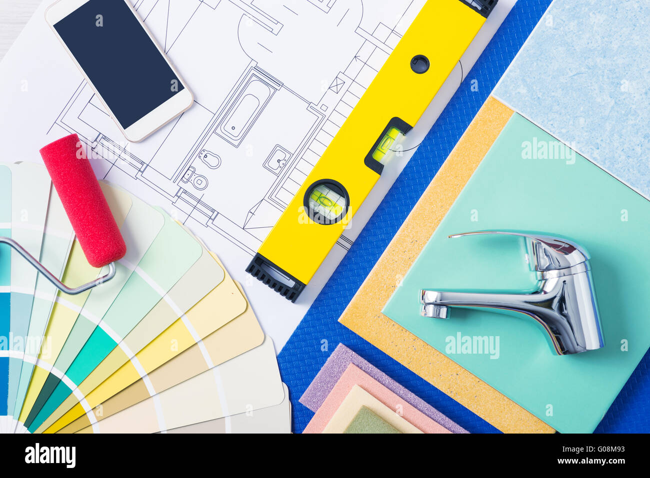 Home repair and decorating concept with color swatches, tiles, faucets and mobile phone, top view Stock Photo