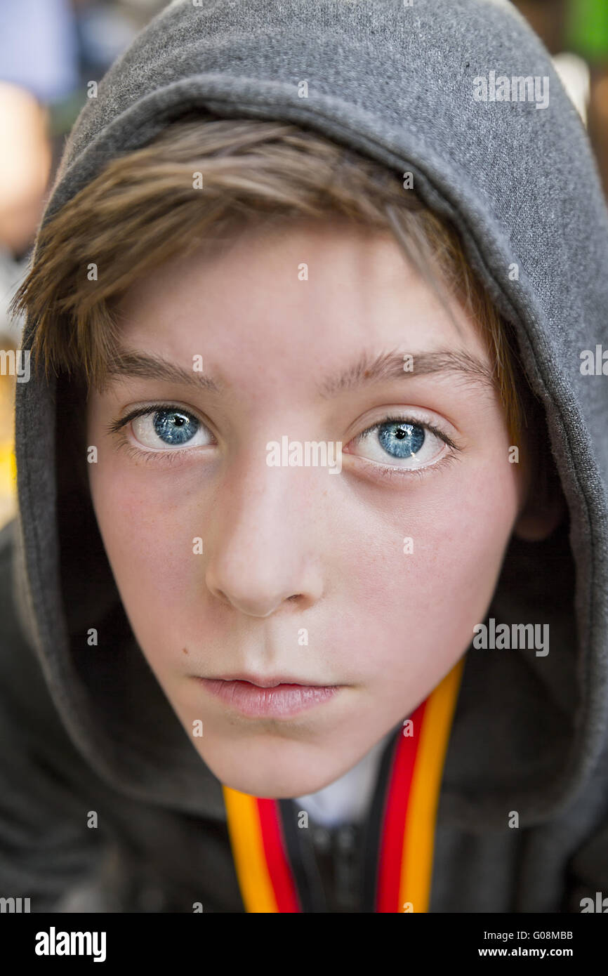 portrait of a teenage boy with grey hoodie sweatshirts, after sports with red face Stock Photo