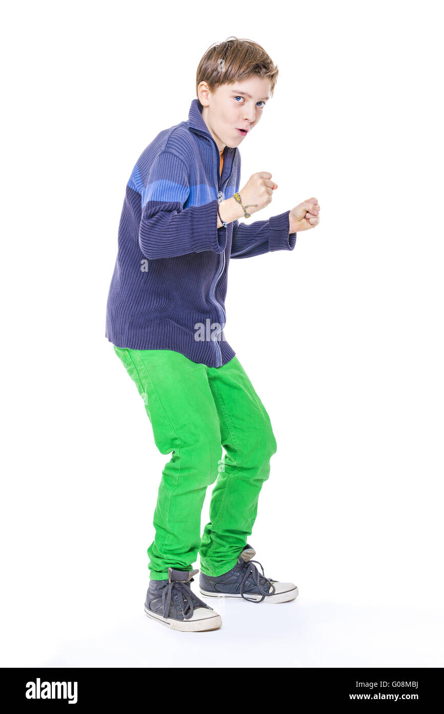 casual cool teenage boy clenches his fists, isolated on white Stock Photo