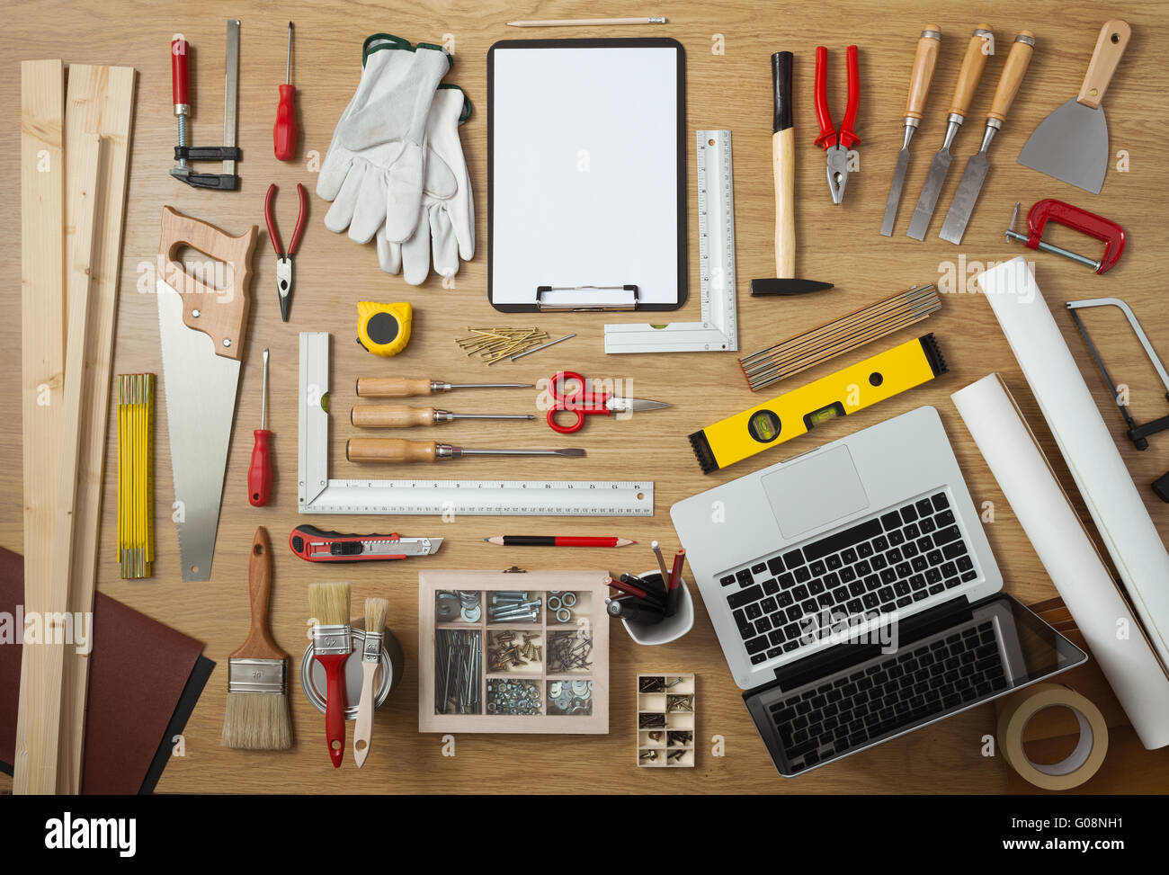 Blank project on a clipboard with DIY tools all around on a work table, top view Stock Photo