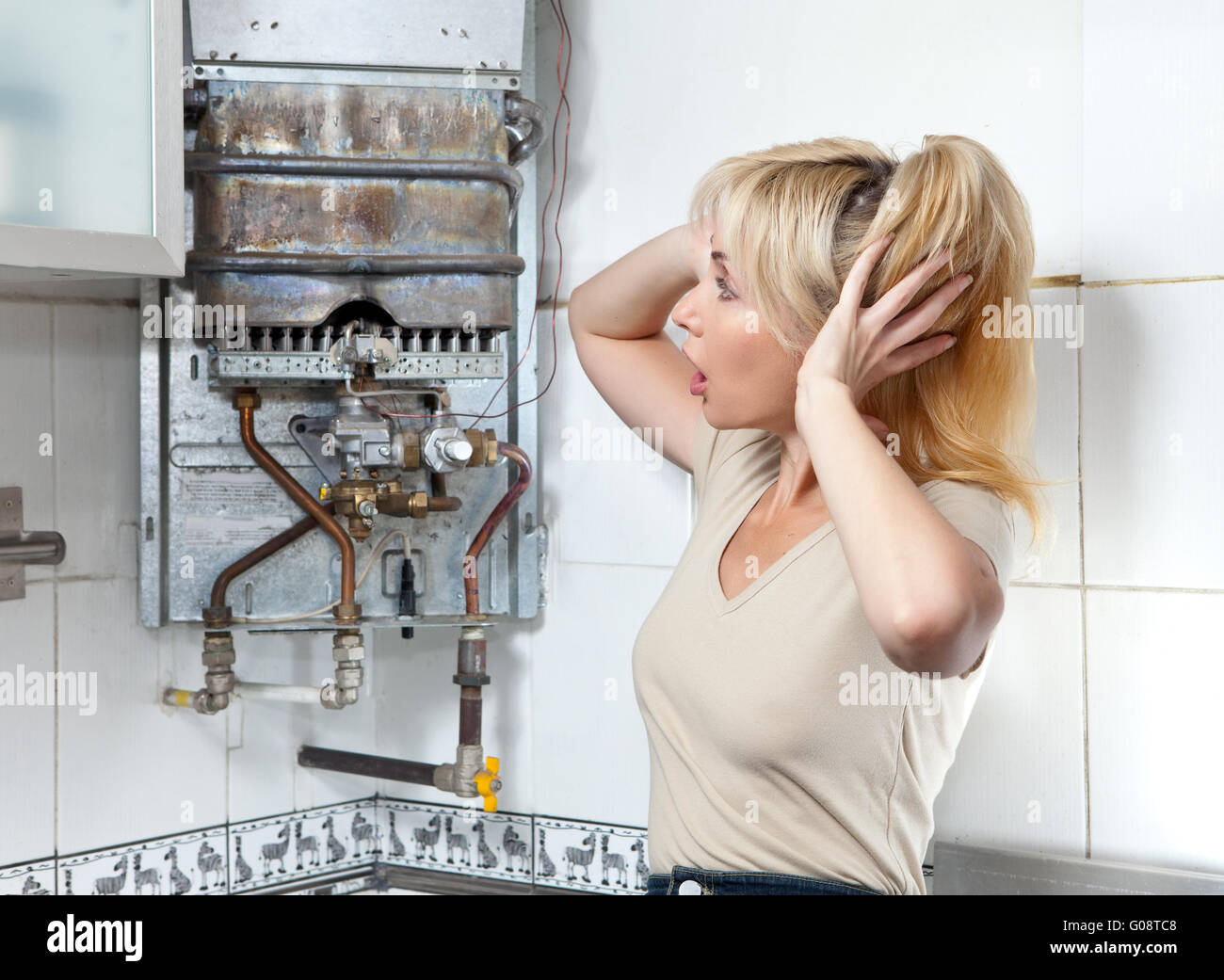 housewife is upset, the gas water heater has broke Stock Photo