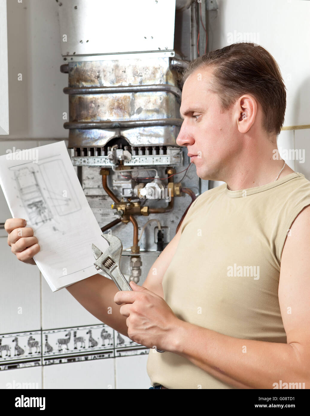 The man is upset, the gas water heater has broken Stock Photo