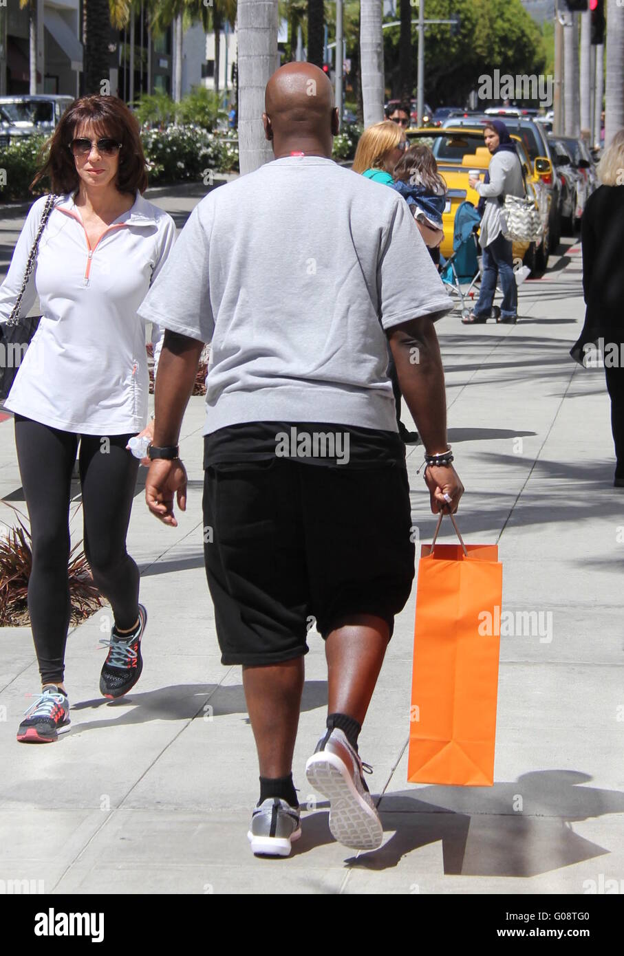Corey Gamble carries a Hermes shopping bag on Rodeo Drive Featuring ...