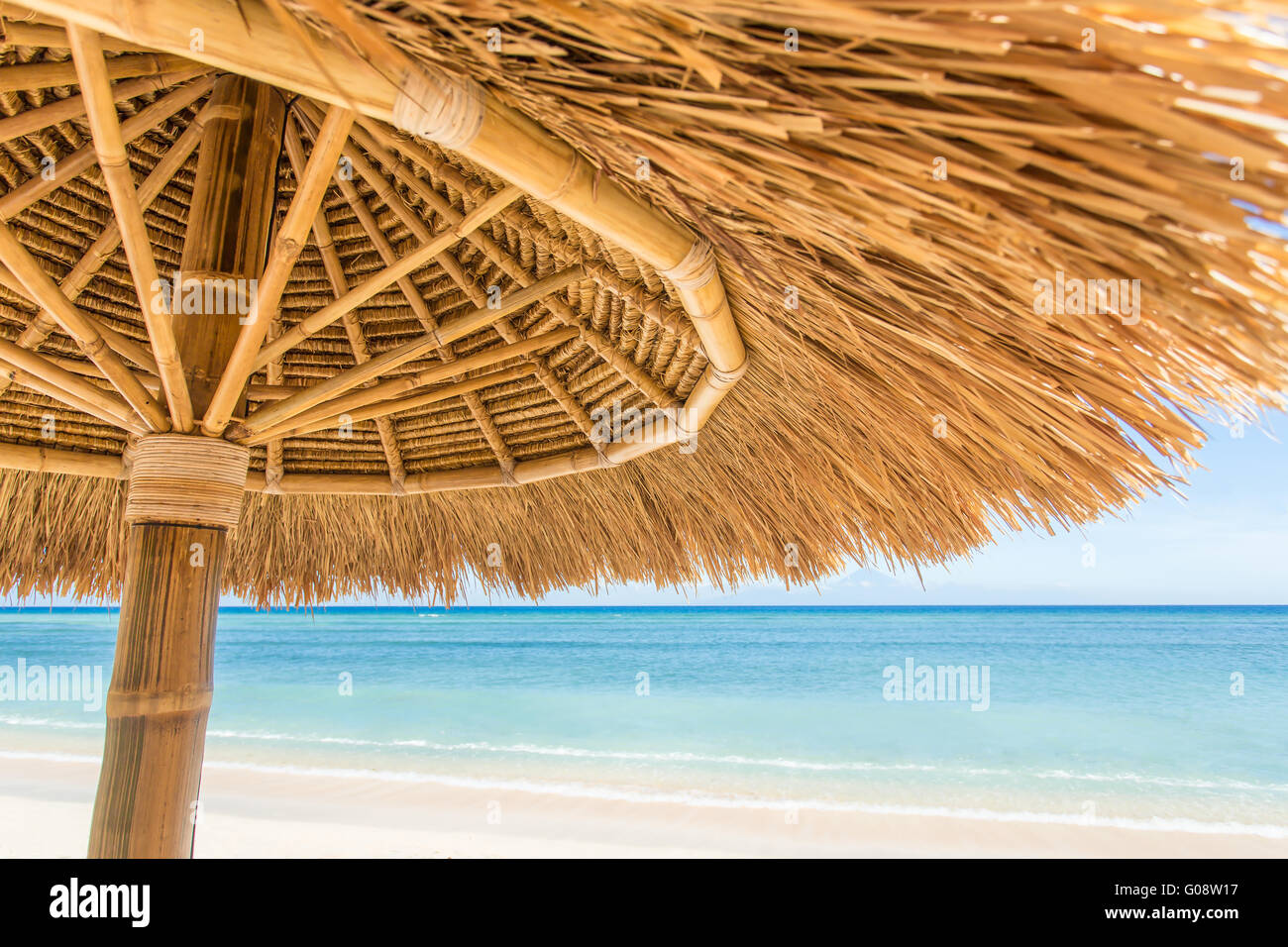 Straw umbrella on a beautiful tropical beach Stock Photo Alamy