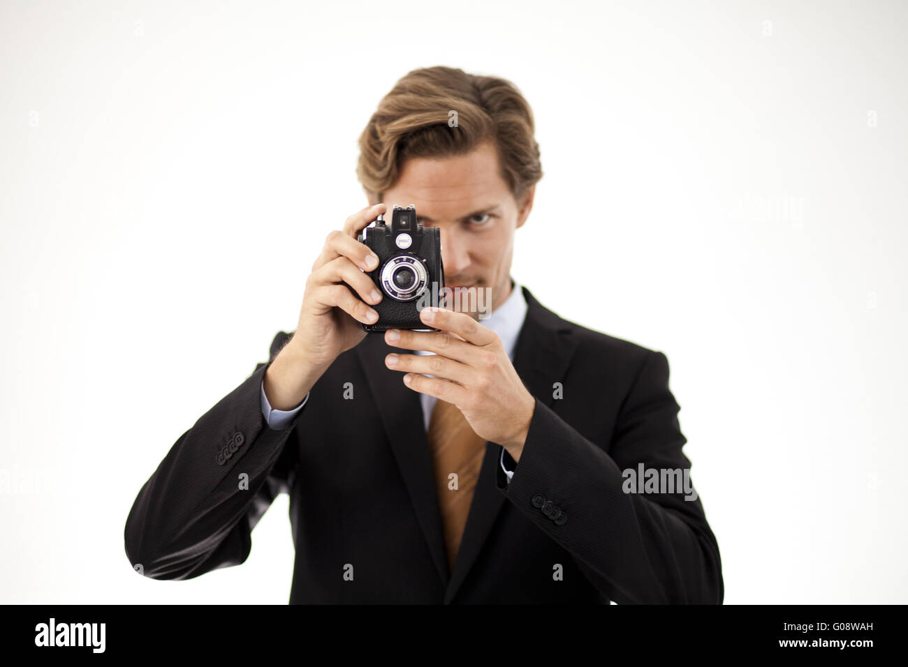 Businessman holding old camera Stock Photo