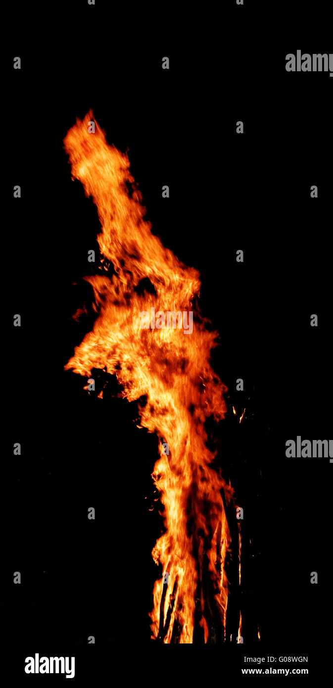 red flames of huge bonfire or campfire as black backgorund Stock Photo