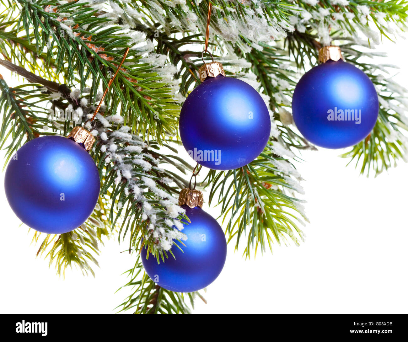 Dark blue New Year's balls on a snow-covered branc Stock Photo