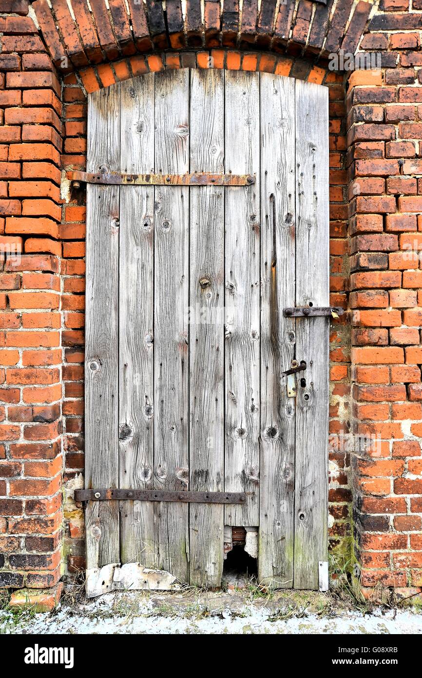 old wooden door of an abandoned factory building Stock Photo