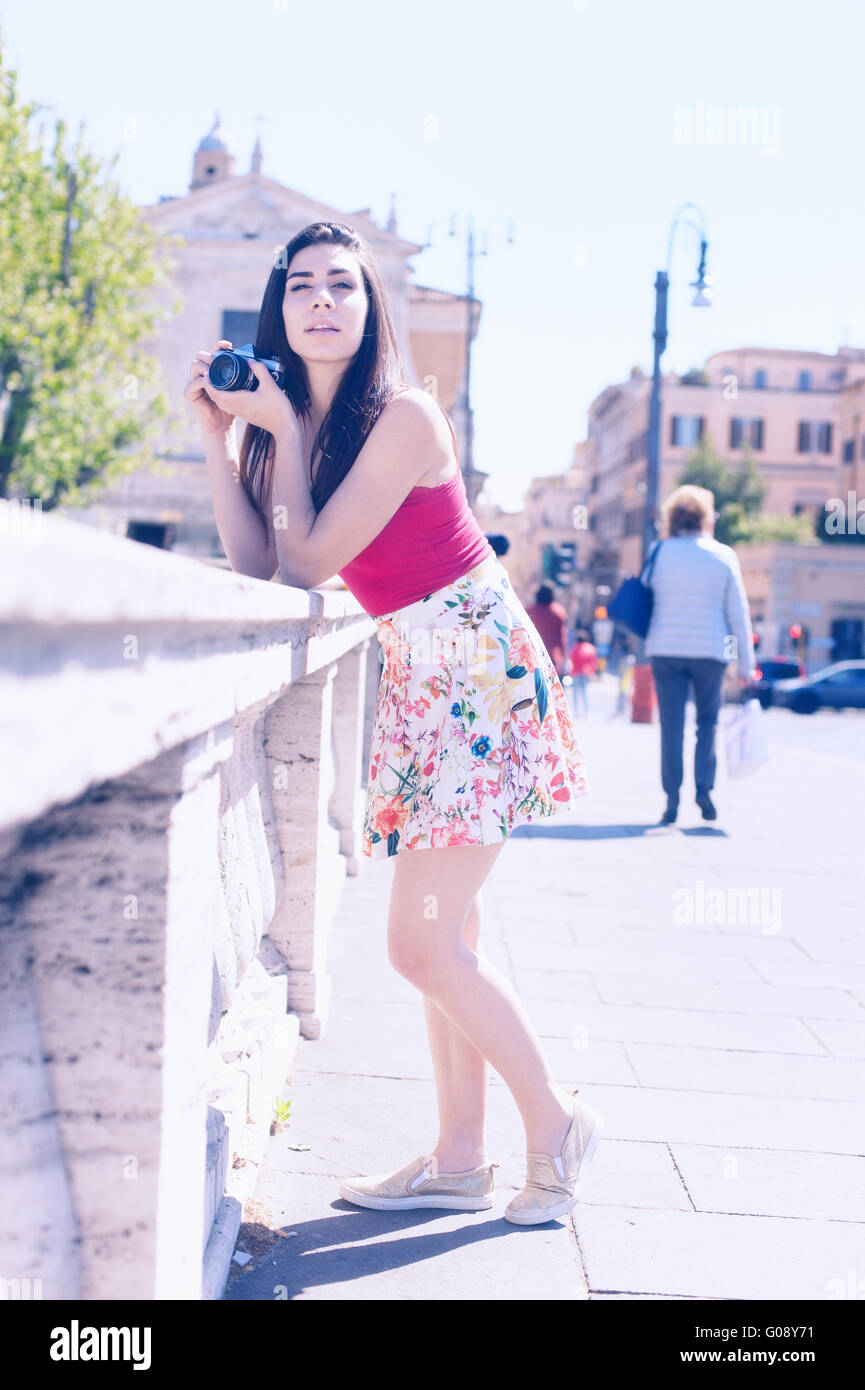 Young woman tourist taking photo outdoor with vintage camera Stock Photo