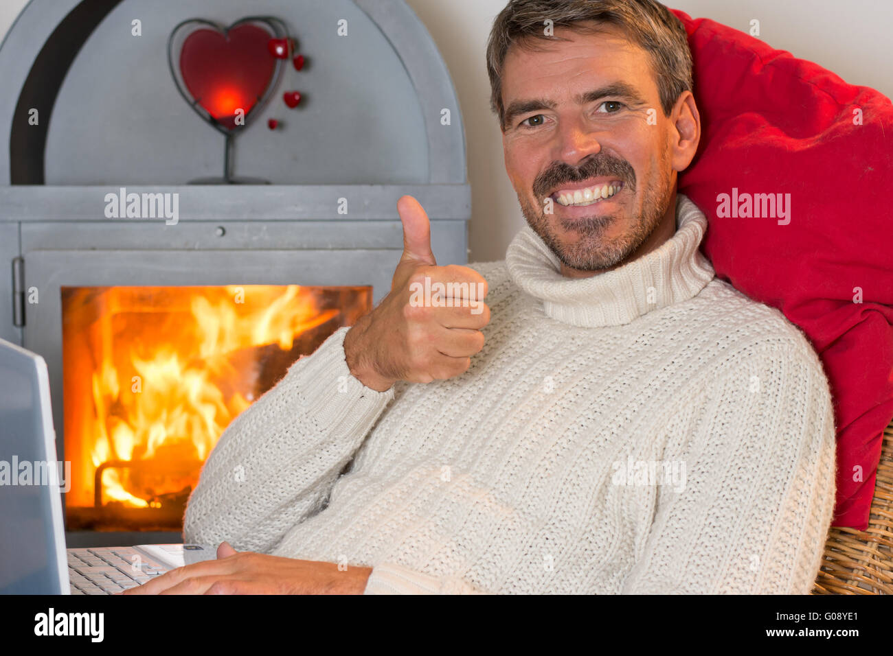 Man at home in front of a fireplace Stock Photo Alamy