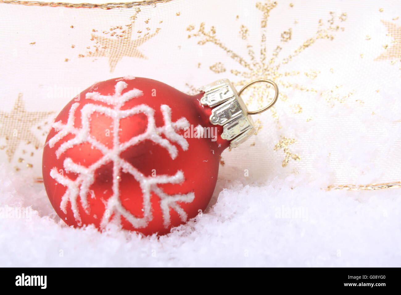 red christmas balls with white pattern on artifici Stock Photo