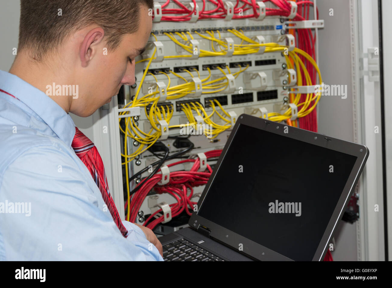 young it engineer in network server room Stock Photo