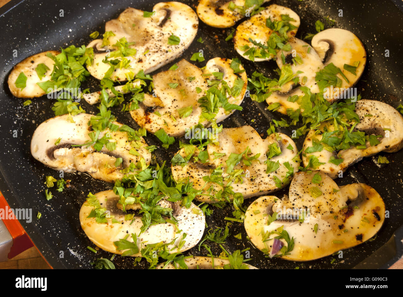 Cooked field mushrooms in pan with olive oil, pars Stock Photo Alamy