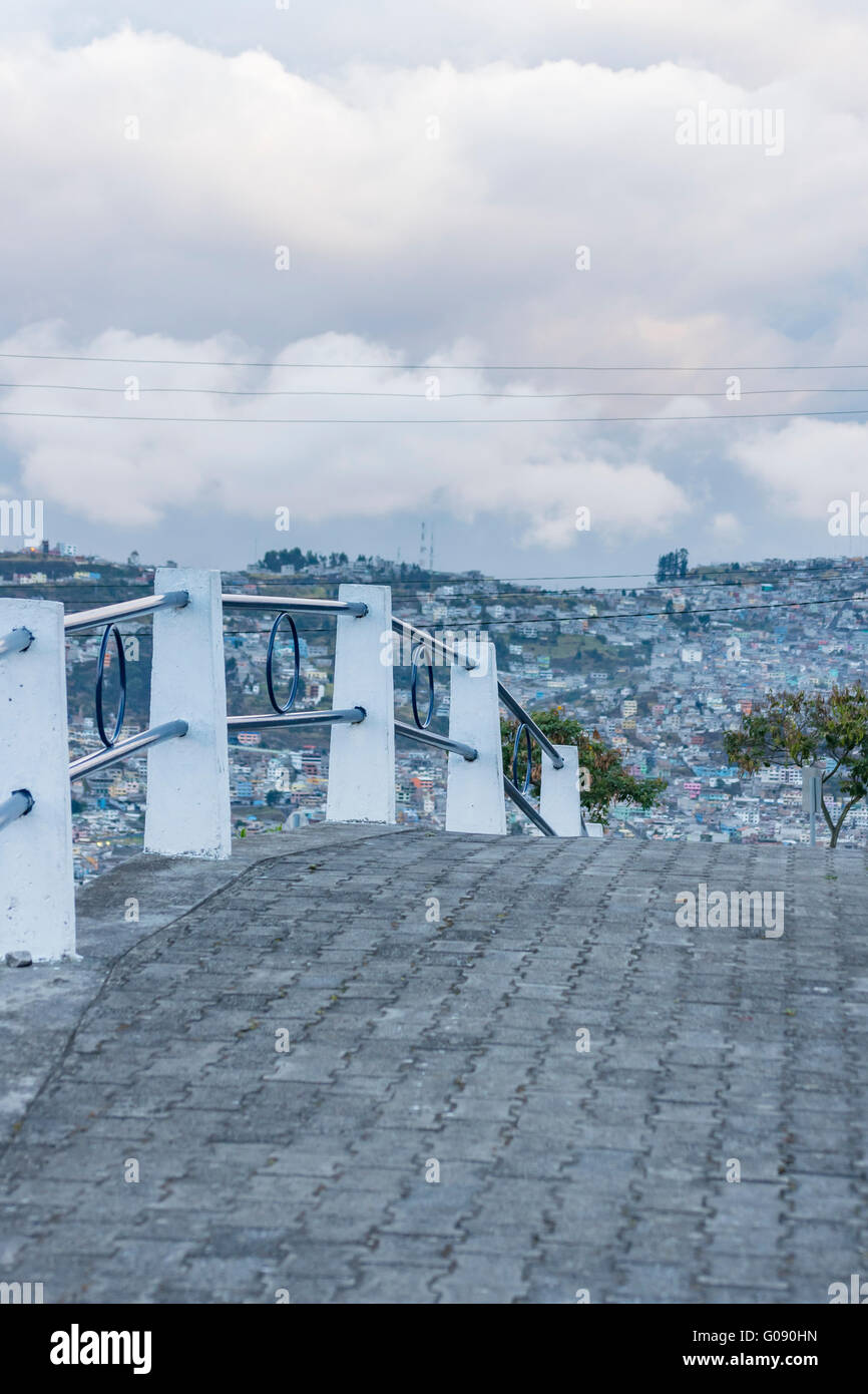 Cityscape panoramic aerial view from cobblestone street at panecillo viewpoint of Quito city, Ecuador. Stock Photo