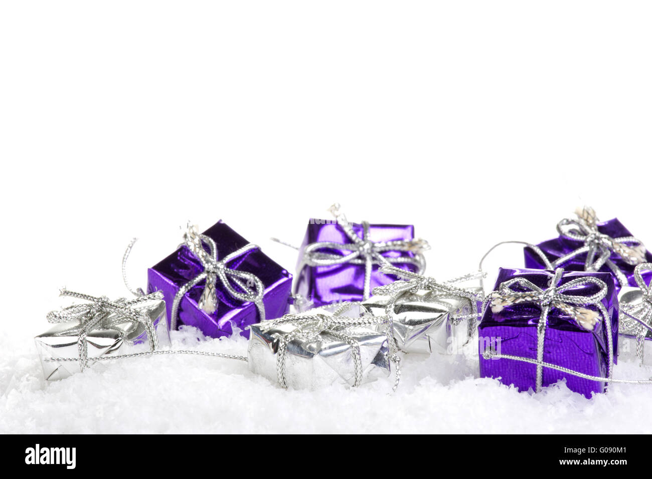 Presents purple and silver on artificial snow with Stock Photo