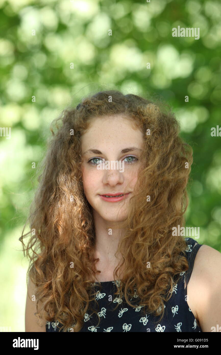 Portrait of beautiful young woman with curly long outdoor Stock Photo ...