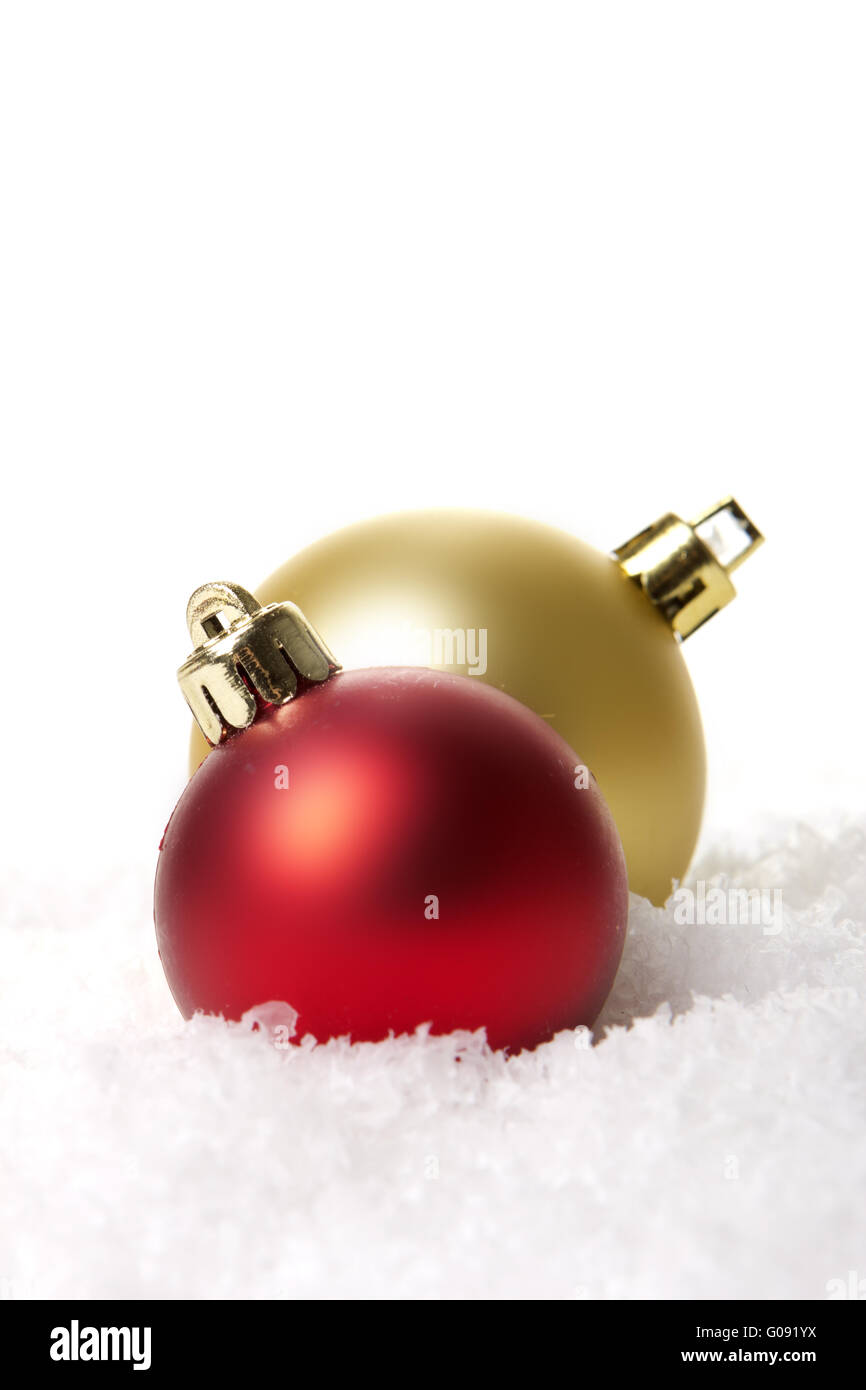 red and golden christmas balls on artificial snow Stock Photo