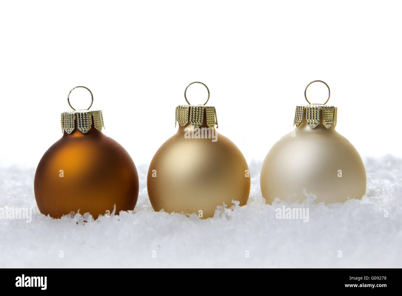 creme christmas balls on artificial snow with whit Stock Photo